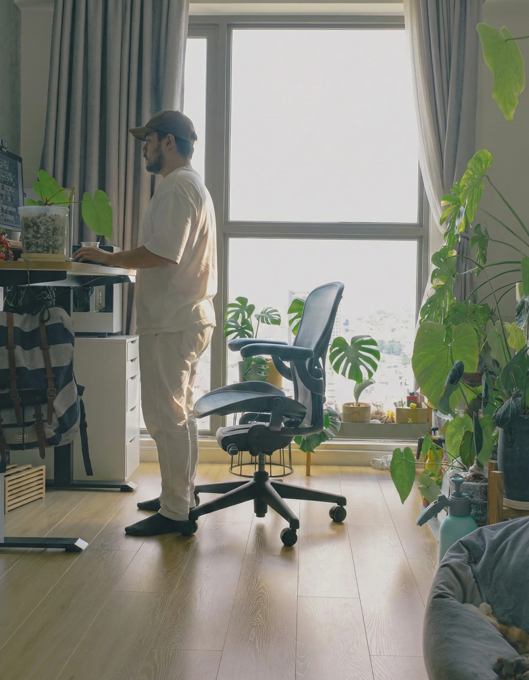 Melih standing at desk